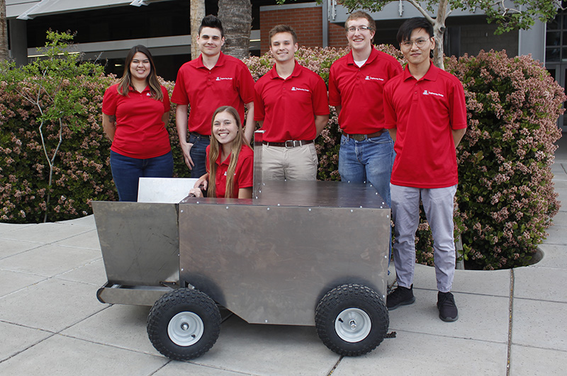 Students stand with project prototype on UArizona campus
