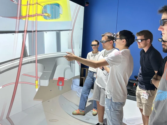 students wearing virtual reality glasses examine an image on a large screen.