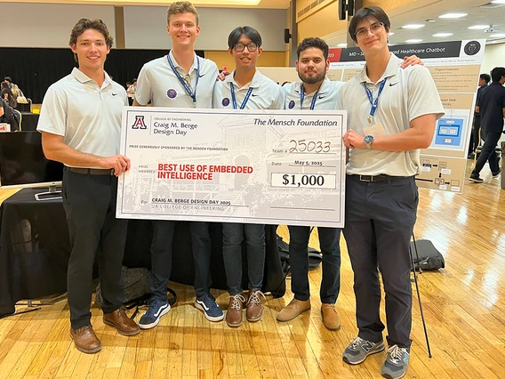 Five men in white shirts hold up a big check.