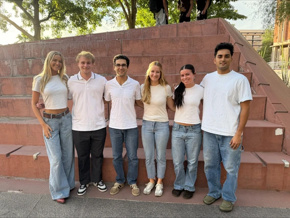 A variety of students pose for a photo together.