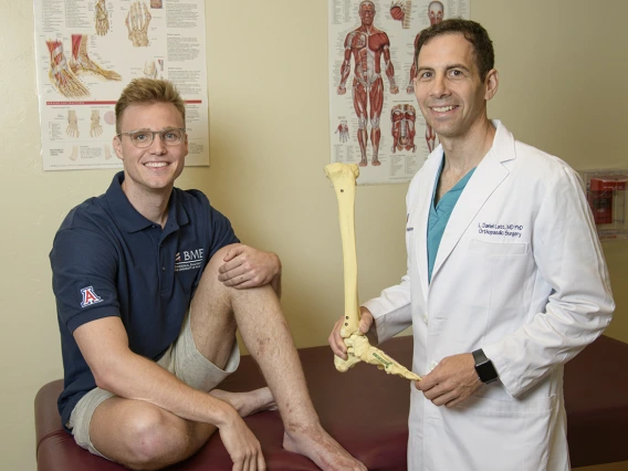 Photo of Ian Jackson & Dr Daniel Latt in exam room with skeletal foot model