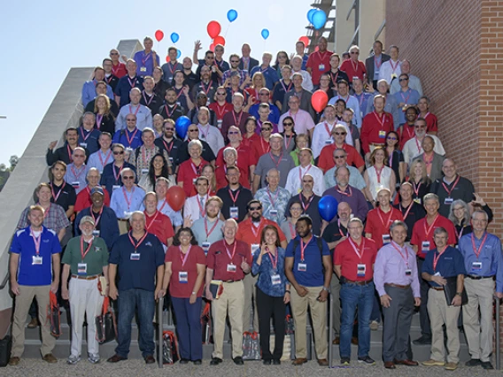 The judges, sponsors and mentors of Design Day 2018 stand on the stairs outside the Student Union Ballroom.