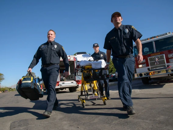 Tucson medical responders wheel someone into the emergency room.