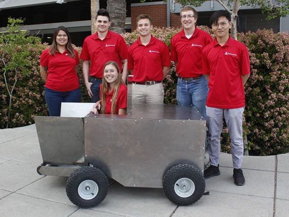 Students stand with project prototype on UArizona campus 