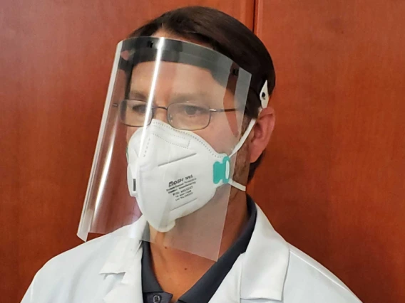 Image of a doctor wearing a face shield and mask