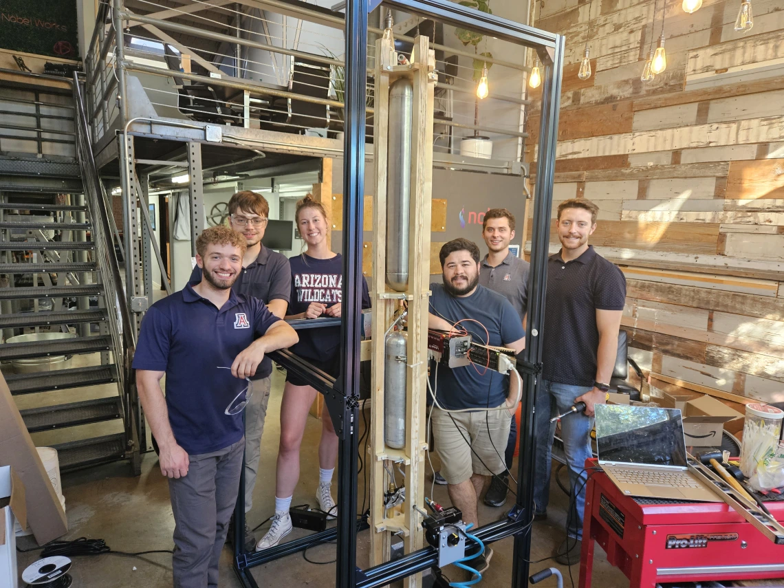 Six students pose for a photo inside a lab.