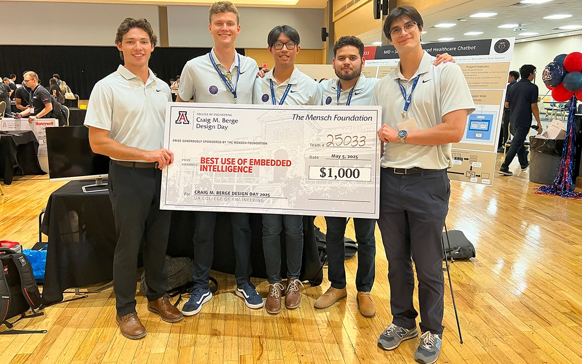 Five men in white shirts hold up a big check.