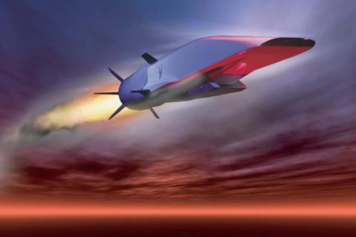 A hypersonic vehicle flys across a sunset sky.