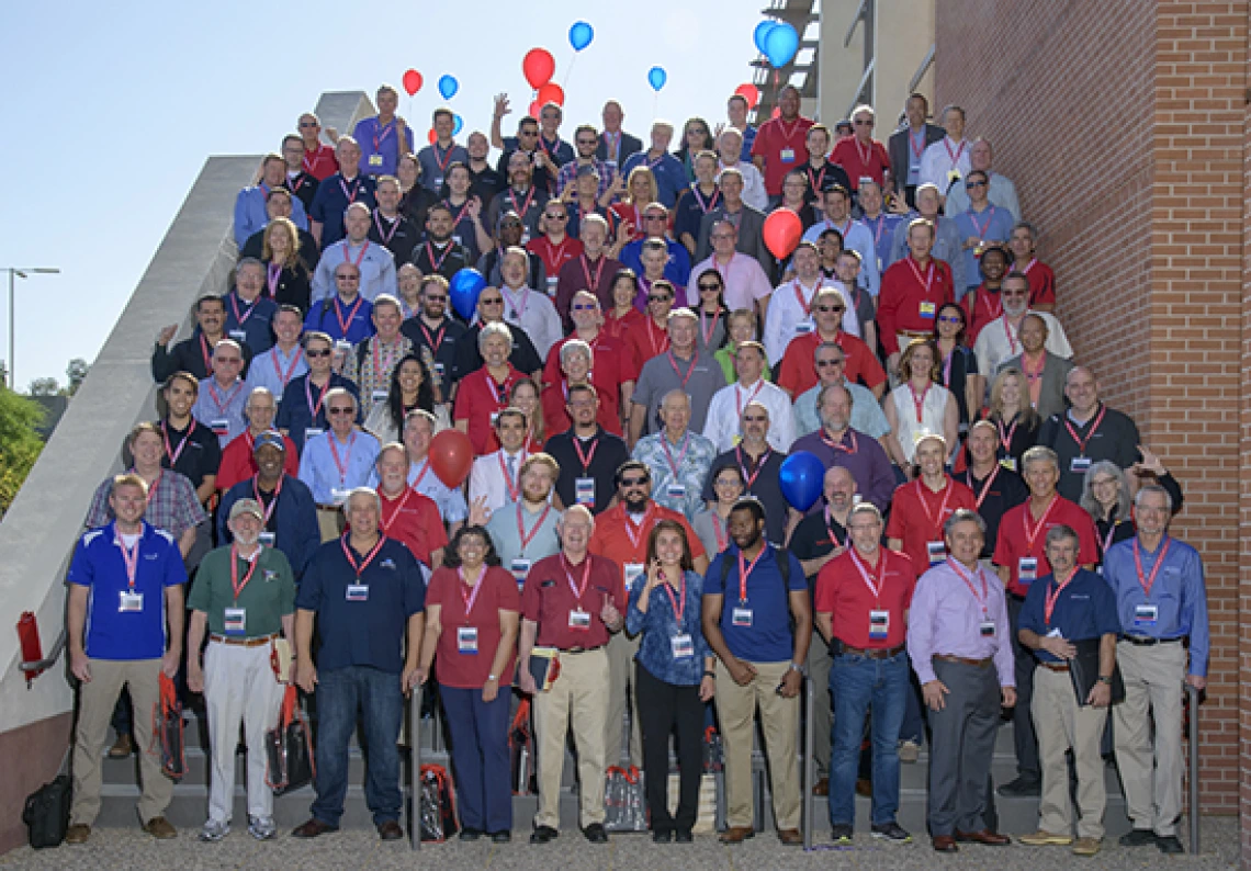 The judges, sponsors and mentors of Design Day 2018 stand on the stairs outside the Student Union Ballroom.