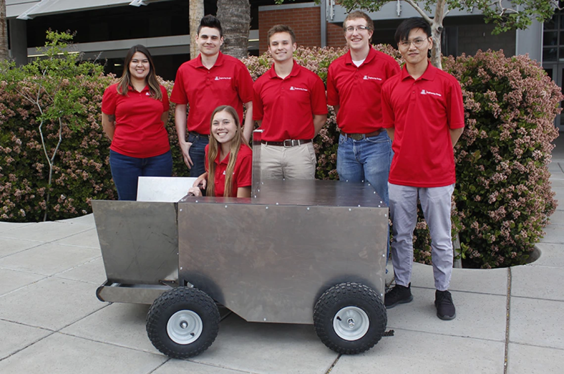 Students stand with project prototype on UArizona campus 