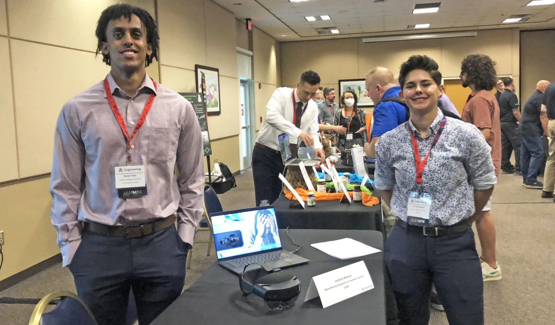 two people at a conference booth