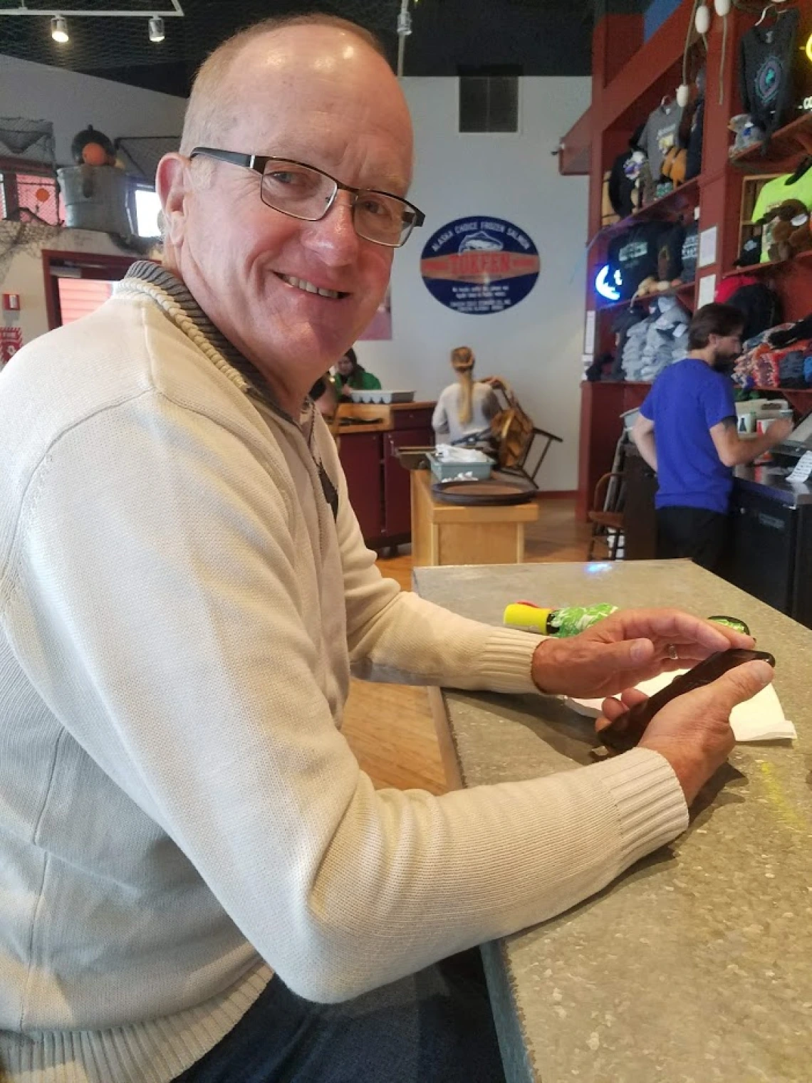 Photo of Claude Merrill sitting at a counter