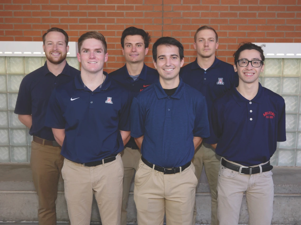 six students posing outside a campus building