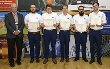 University students with presenter giving them a award certificates