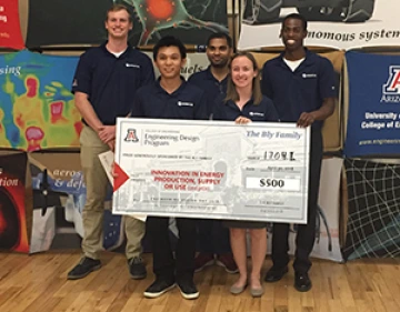 University students with a large award check