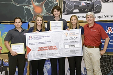 University students with presenter giving them a large award check