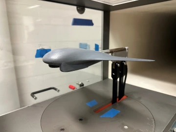 a small plane model inside a 3D printer