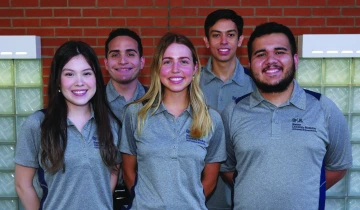 5 students pose outdoors