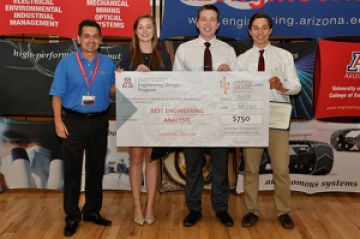 University students with presenter giving them a large award check