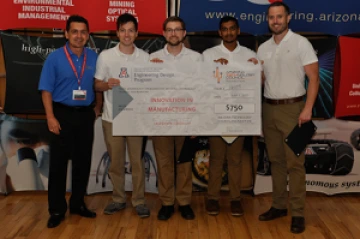 University students with presenter giving them a large award check