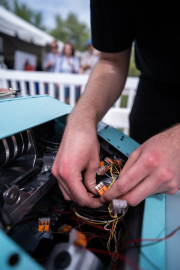 a student handles the battle robot's inner workings