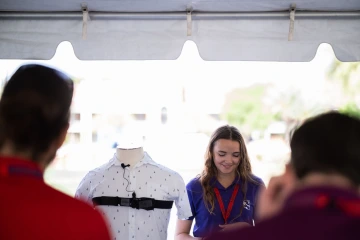 Logan Deane stands at the Design Day booth