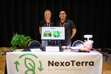 Andrew Arias and his business partner stand at their event booth