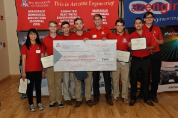 University students with a large award check