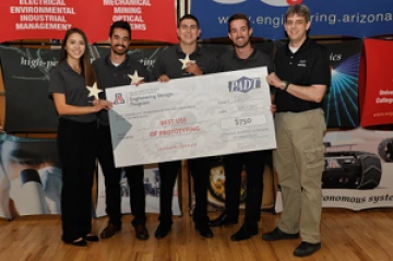 University students with a large award check