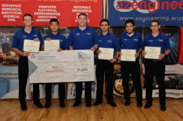 University students with a large award check