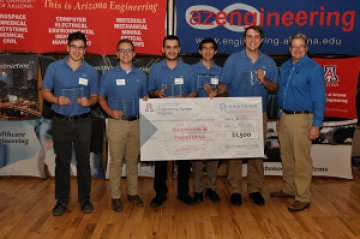 University students with presenter giving them a large award check