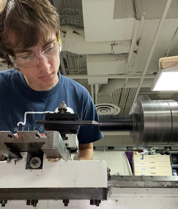 a student building car parts