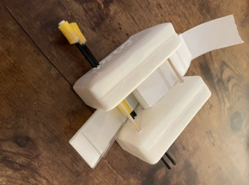 Two bars of soap connected by toothpicks. Looks similar to a tape dispenser.