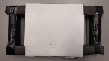 a taped-together prototype with a speaker area drawn on paper