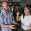 A man and a young woman hold a bike pedal.