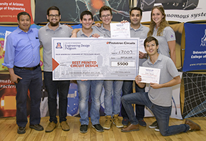 University students with presenter giving them a large award check