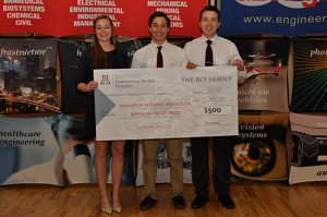 University students with a large award check