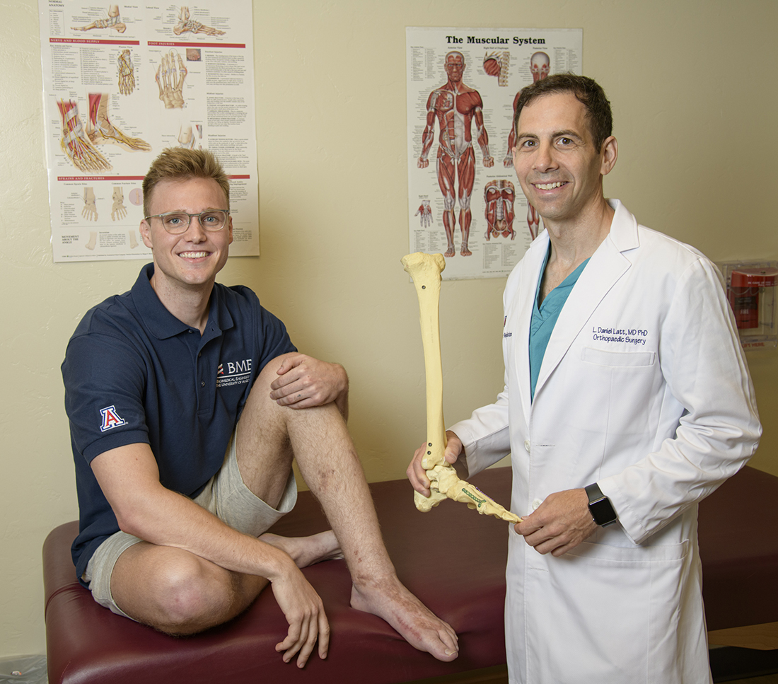 Photo of Ian Jackson & Dr Daniel Latt in exam room with skeletal foot model