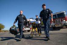 Tucson medical responders wheel someone into the emergency room.