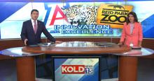 Screenshot of a newscast. Two anchors sit at a news desk. behind them, a photo of a jaguar.