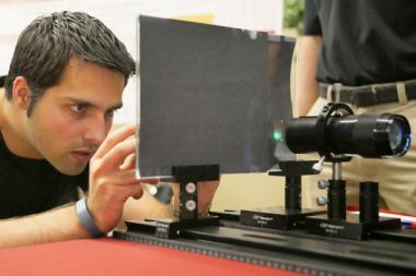 A male university student working on a holographic head-up display