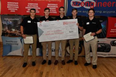 University students with large award check