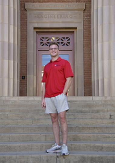 Image of Ian Jackson standing on steps in front of Old Engineering building at U of A