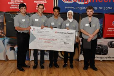 University students with a large award check
