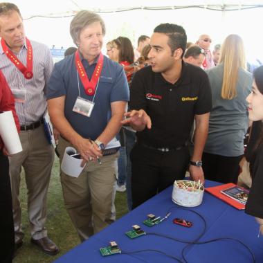 Judges interview a team at Engineering Design Day