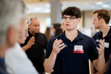 a student speaks with judges