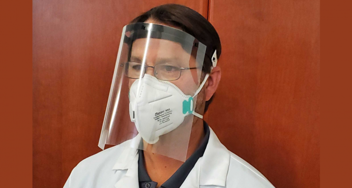 Image of a doctor wearing a face shield and mask