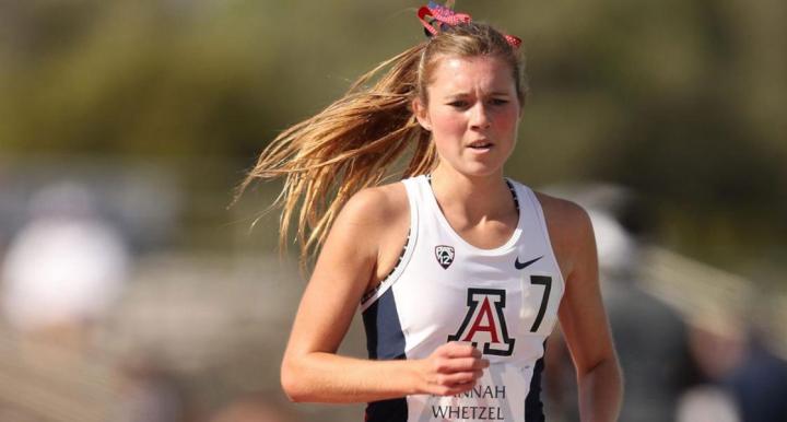 Girl running in University of Arizona team jersey