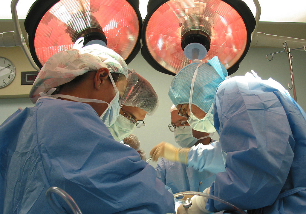 physicians perform surgery