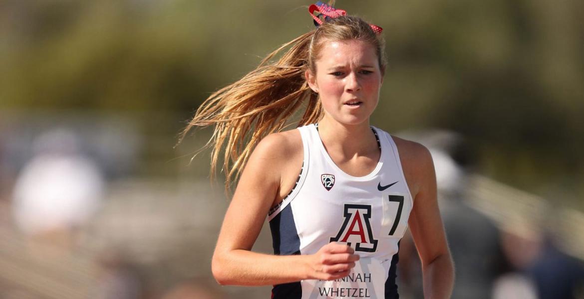 Girl running in University of Arizona team jersey